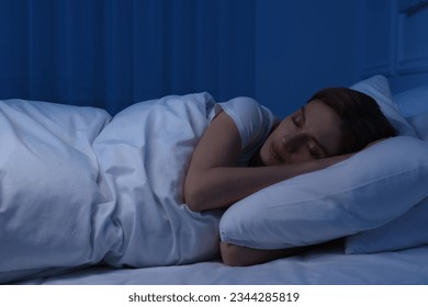 Beautiful woman sleeping in bed at night