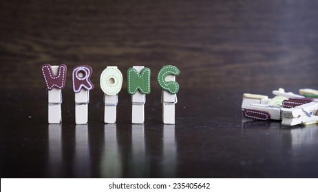 Common business terms - Slightly defocused and close-up of WRONG word on clothes peg stick with lots of clothes peg at background