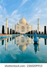 Taj Mahal: Iconic Indian mausoleum built by Shah Jahan in memory of Mumtaz Mahal in 1653. Blend of Parsian, Islamic, Indian influences. UNESCO World Heritage Site symbolising love, Mughal architecture