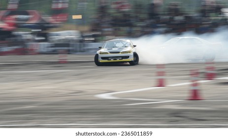 Drift sport racing car drifting with smoke on asphalt track motion blur