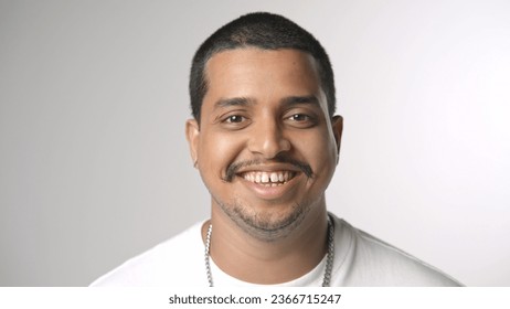 One mexican person look camera. Happy latino guy face portrait white background. 30 year old rap artist head shot. 40 american man smile close up. Hispanic young adult arab life. Male dark hair mexica