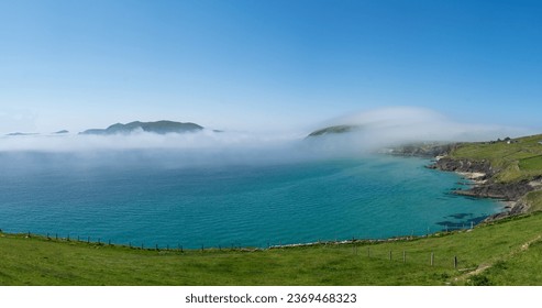 Morska megla in megla do otoka Great Basket v bližini pomola Dunquin preko ceste Slea Head Drive na polotoku Dingle na poti Wild Atlantic Way v Kerryju na zahodni obali Irske.