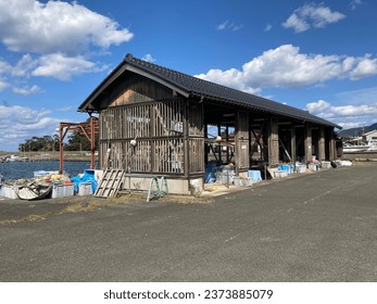 This is a wooden building located in a Japanese fishing port.