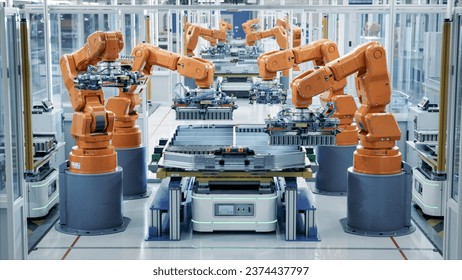 Row of Robot Arms inside Bright Plant Assemble Batteries for Automotive Industry. EV Battery Pack Automated Production Line Equipped with Orange Advanced Robotic Arms. Electric Car Smart Factory