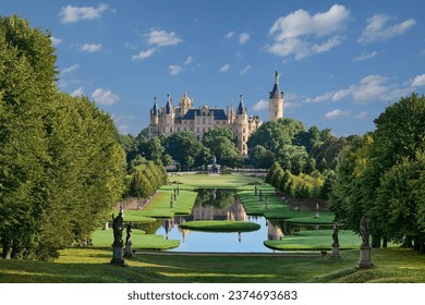 castle of Schwerin behind the beautiful castle park. Rections in the chanal system of the ancient building, Schwerin, Mecklenburg-Pomerania, Germany