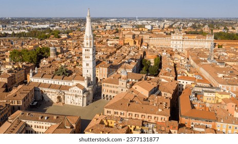 Aerial view of the Modena Cathedral and Torre della Ghirlandina, the bell tower of this Roman Catholic church. In background there is the Ducal Palace of Modena, Emilia Romagna, Italy.