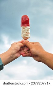 corndog sa majonezom i sosom od paradajza sa pozadinom plavog neba