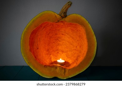 Vela ardiendo dentro de una calabaza limpia, interior tallado, textura abstracta, enfoque suave de cerca