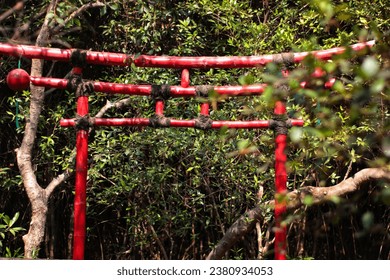 Red bamboo gate from Japanese culture in the mangrove forest park