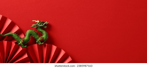 2024 Chinese New Year Banner: Abstract Art with Oriental Dragon and folding paper fans on red background. Lunar New Year Celebration Card Design