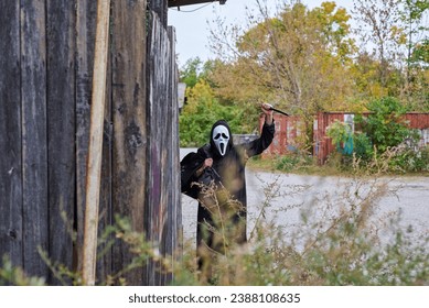 A man with a ghost mask is holding a knife