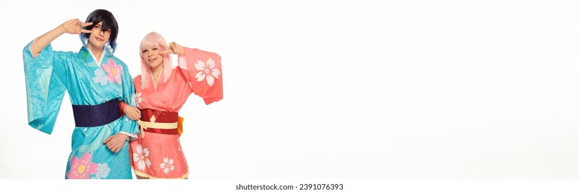 joyful anime style couple in bright kimonos showing victory sign on white, horizontal banner