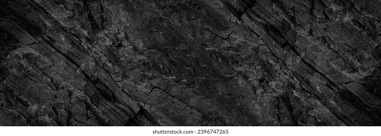 Crno bijela tamno siva kamena kamena granitna tekstura pozadine za dizajn. Close-up. Napukla izmrvljena hrapava planinska površina. Široki baner. Panoramic. Prazan prostor.