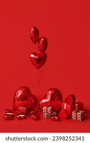 Heart shaped air balloons and gift boxes on red background