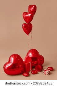 Heart shaped air balloons and gift boxes on brown background