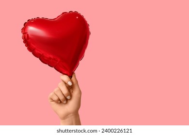 Woman with air balloon in shape of heart on pink background. Valentine's Day celebration