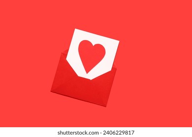 Composition with envelope, card and paper heart on red background. Valentine's Day celebration