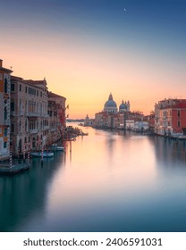 Venice grand canal view, Santa Maria della Salute church at sunrise and the moon. Italy, Europe.