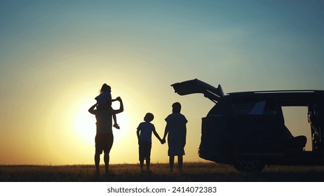 family traveling by car. family watching sunset silhouette next to the car in the park. happy family kid dream concept. people in the park. family car camping resting in nature lifestyle