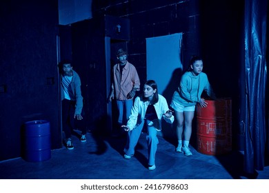 group of multicultural young people engaged in thrilling escape room challenge, indoor adventure