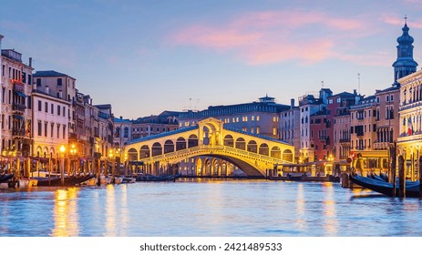 Panoramic view of famous Canal Grande with famous Rialto Bridge at sunset in Venice