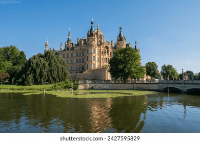 Stunning Schwerin Castle in northern Germany, surrounded by beautiful trees and lake