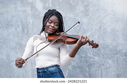 Portrait smile confident teenager long hair black woman play violin on street. Education music instrument  modern minimal style.