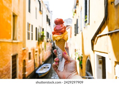 hand holding gelato in venice canal