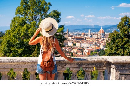 back view of young female tourist in Italy- Florence city landscape panoramic view