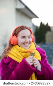 young happy carefree girl holds rose in her hands