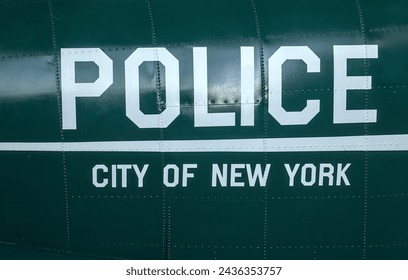 police city of new york sign on the side of vintage antique airplane body