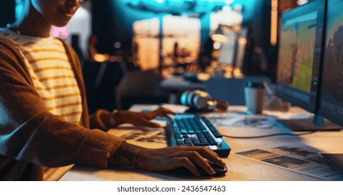 Portrait of Female Video Game Designer Working on a New 3D Level on Desktop Computer in Creative Office. Black Focused Woman Creating Metaverse and Adding Details to a Game Environment