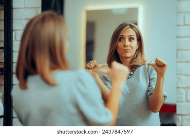 Woman Looking in the Mirror Pointing to herself at the Salon. Self-obsessed vain girl checking herself in a mirror