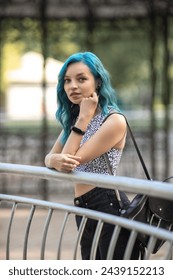 Portrait of a young beautiful slender girl with blue hair.