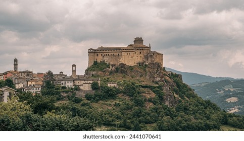 The castle and the village of Bardi in a cloudy day. Parma province, Emilia and Romagna, Italy.