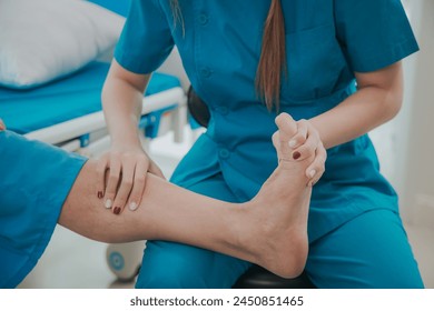Asian female physical therapist helps an elderly man stretch his Achilles tendon, physical therapy rehabilitation, elderly. Causes knee pain, swelling, redness, stiffness of the knee, and a rumbling s