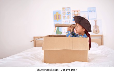 Young, boy or box for pirate with creativity in home, playing game with telescope. Male child or cardboard or bedroom at house with youth, captain for halloween in fantasy ocean or apartment with fun