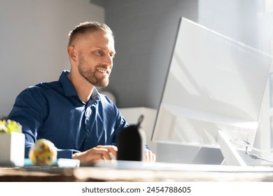 Office employee working at desktop computer using email