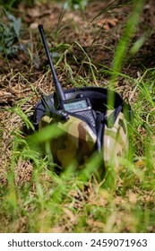 Military equipment, tactical headphones and a walkie-talkie in the forest on the ground. Military actions, war in Ukraine