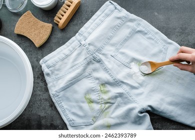 Eng Fra Handpudder e Gras Flecken Bakpulver op bloe Jeans. Natierlech Botzen Produiten. Null Offall Konzept. erop Vue. Héich Qualitéit Foto