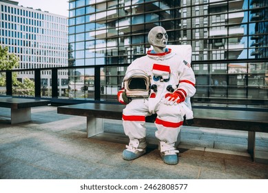 Alien spaceman in a futuristic station. astronaut with space suit walking in an urban area