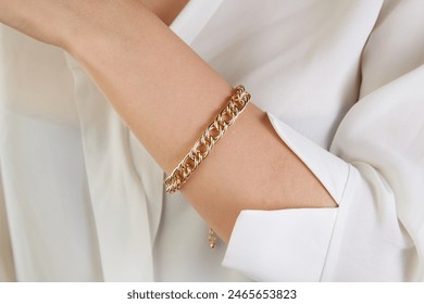 Gold jewelry. Gold bracelet on woman hand