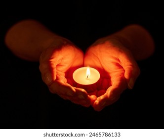 Hands, dark and person with candle, light and offering with religion on studio background. Closeup, model or human with open palms, solidarity or night with support, spiritual or ritual for vigil
