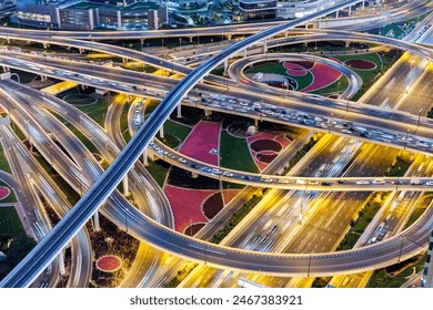 Dubai crossroads of Sheikh Zayed Road highway interchange traffic near Burj Khalifa with metro at twilight