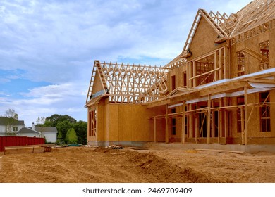 Newly constructed house with unfinished interior with wooden stud timber framing supports beams
