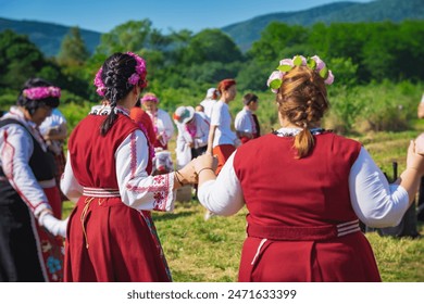 People singing and dancing dressed in traditional clothing. Annual Rose picking ritual in Bulgaria