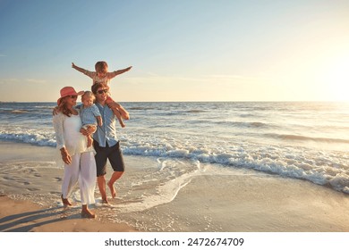 Happy family, beach holiday and walking, smile for vacation on tropical island. Man, woman and children together with sunglasses by ocean for travel with wellness, mockup space at sunset in Mauritius