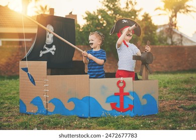 Pirate, boat box and playing with children in backyard for brothers bonding, imagine and creative. Happy, youth and siblings for sailing captain in cardboard ship outdoor for fun, fantasy and games