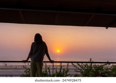 Mature young Indian enjoying sunset at Goa sea beach