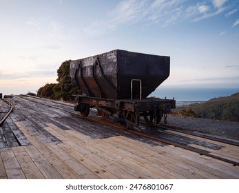 Old historic rusty wagon trolley on abandoned Denniston Incline, coal mining ropeway cable railway track in Buller District West Coast South Island New Zealand